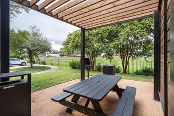 Picnic table under a wooden canopy